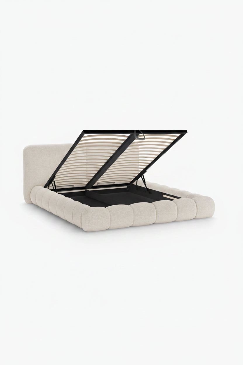 Beige upholstered bed with open metal frame on a white background