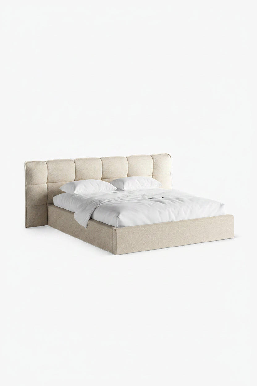 Beige upholstered bed with white bedding on a white background